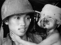 Close up of ARVN holding hurt boy